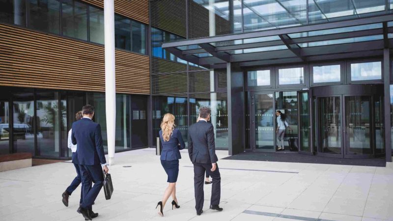 business-people-entering-office-building_11zon